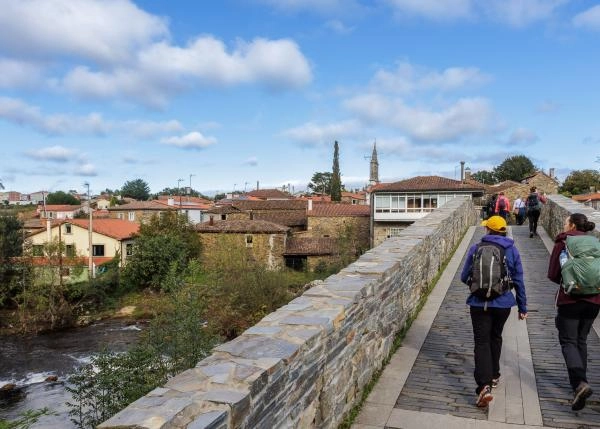 Galicia, La Coruña, Melide, pilgrims on bridge 