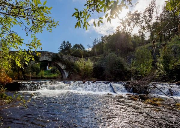 Galicia, La Coruña, Melide, Roman bridge with small waterfall